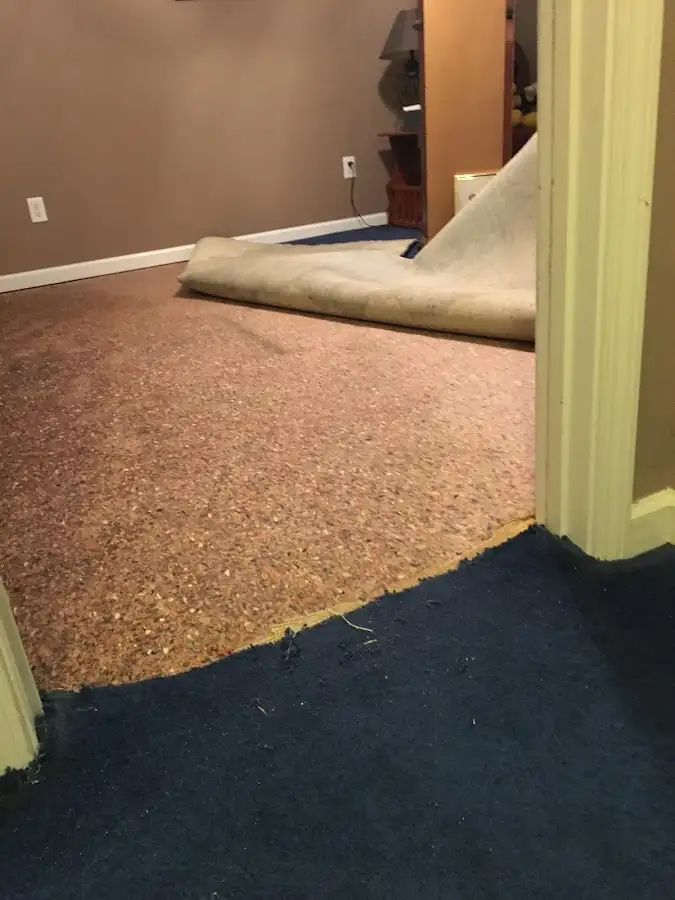 Carpet pad removal revealing water damage during Water Mitigation Services in Gatesville